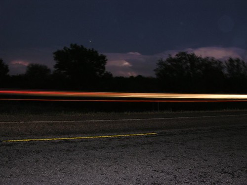lightening lit up the skys and cars going by left light trails